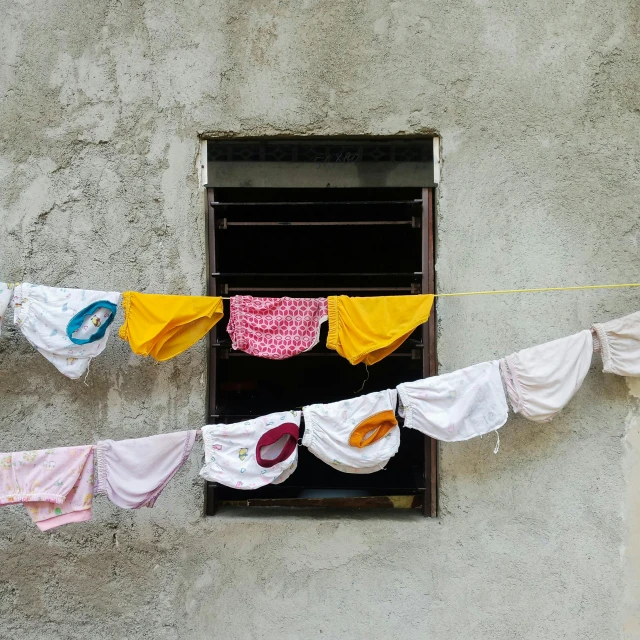a number of clothing hanging out to dry on a clothes line
