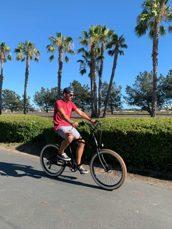 a man is riding a bike down the street