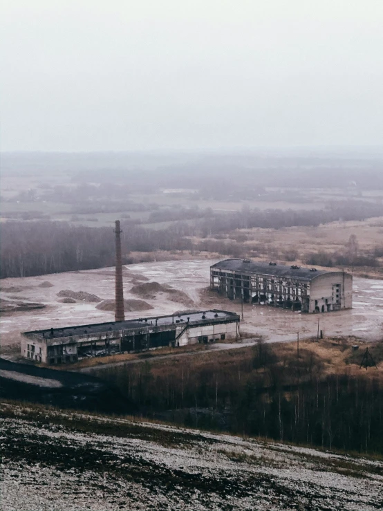 an old building in a deserted area that looks like a nuclear plant