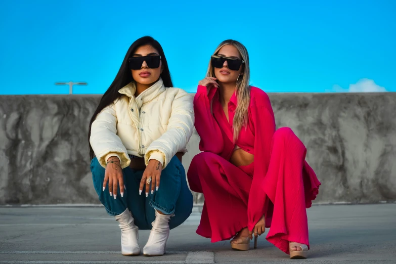 two ladies with sunglasses pose for the camera