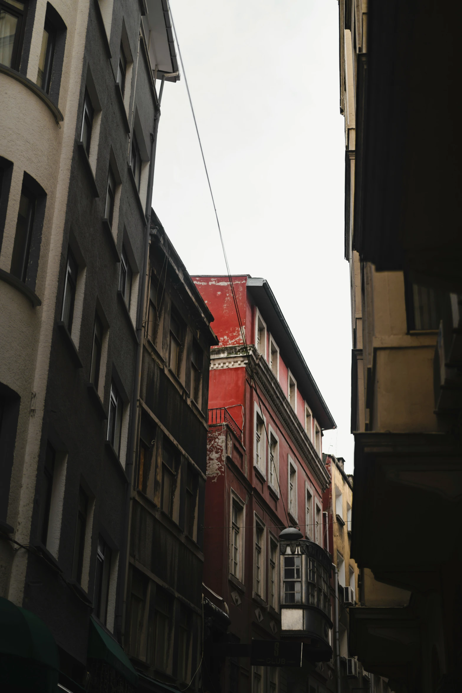 a narrow city street with very tall buildings