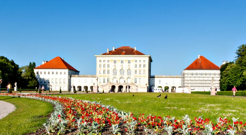 a large building with a lawn in front of it