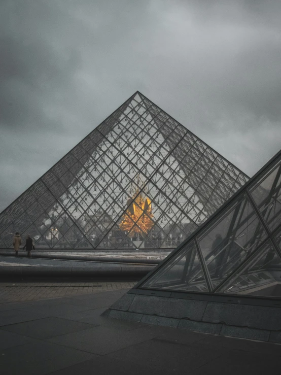 a couple of pyramids are standing in front of some buildings