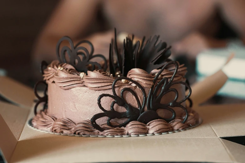 chocolate frosted birthday cake with dark swirls and flowers