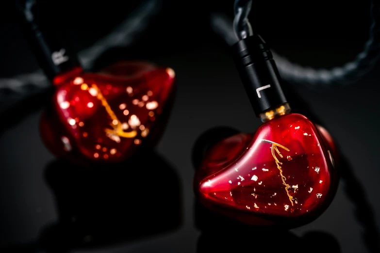 the two red ear phones have sparkle designs on them