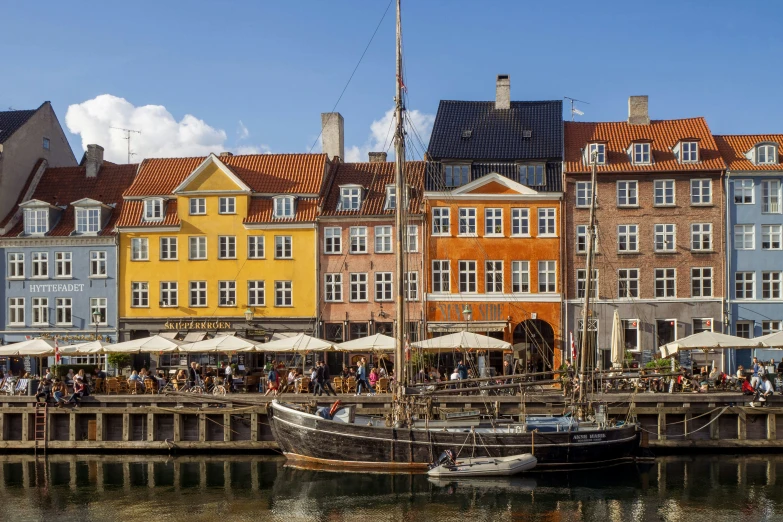 several boats docked in front of buildings on the water