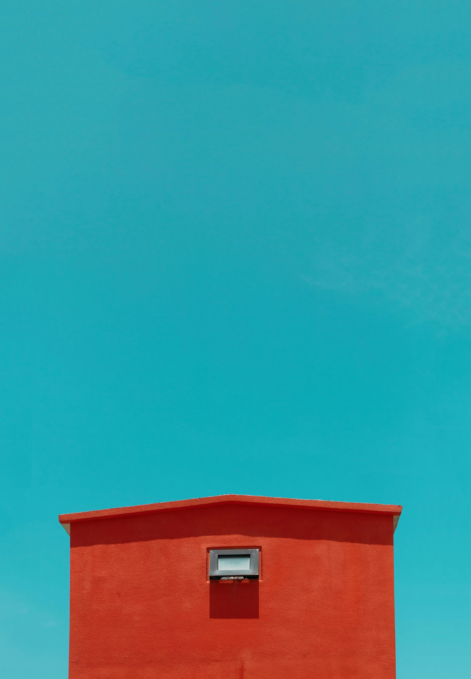the top of a red building on a sunny day