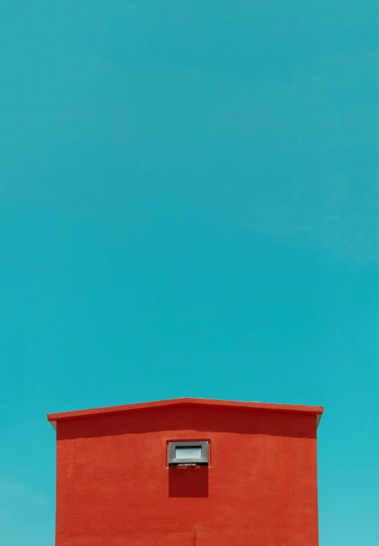 the top of a red building on a sunny day