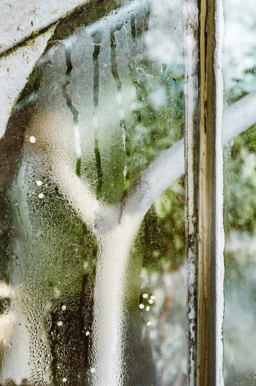 water condenses off the window from outside of a building