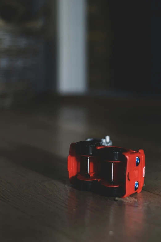 two red plastic object lying on the floor