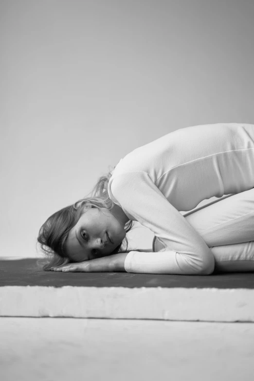 a woman sitting on top of a bed in a room