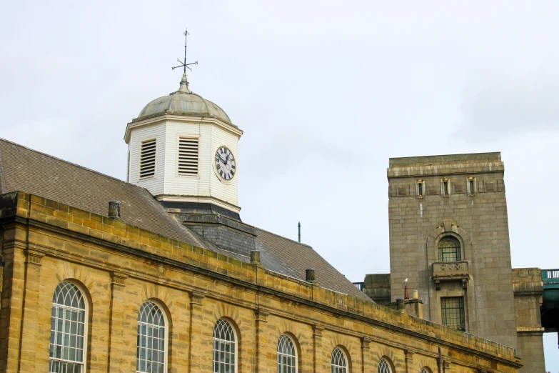 the clock tower above the buildings has a white steeple