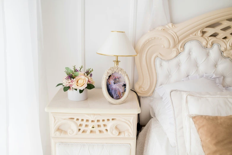 a small vase on the nightstand next to a bed