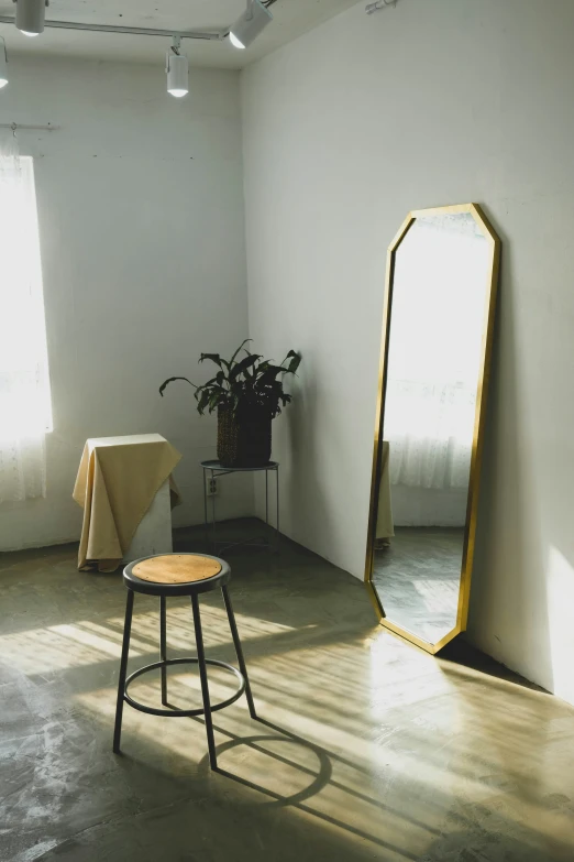 a large mirror sits in front of a small table in a room