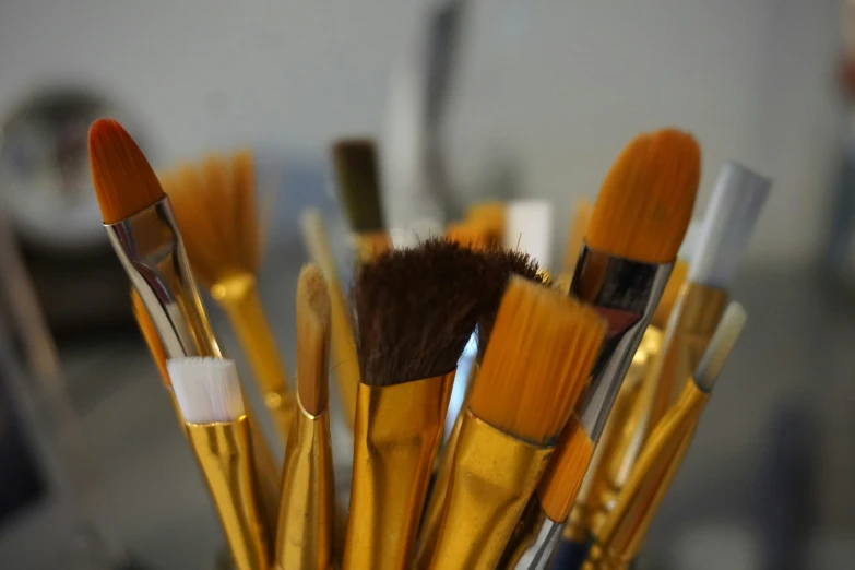 a cup with makeup brushes lined up in it