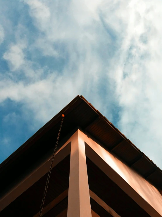 the side of a building with an iron chain in the foreground