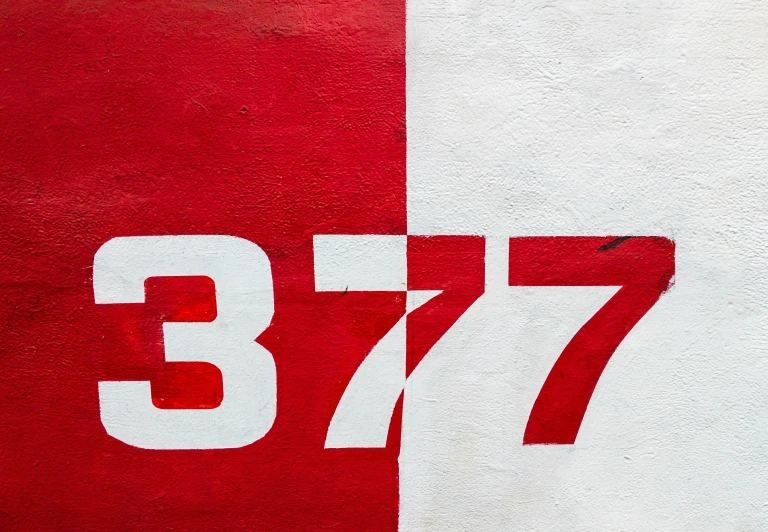 the number seventy is on the wall painted white and red