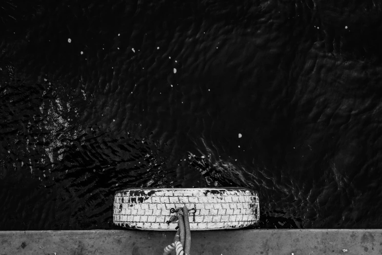 a surfboard laying on top of a cement wall