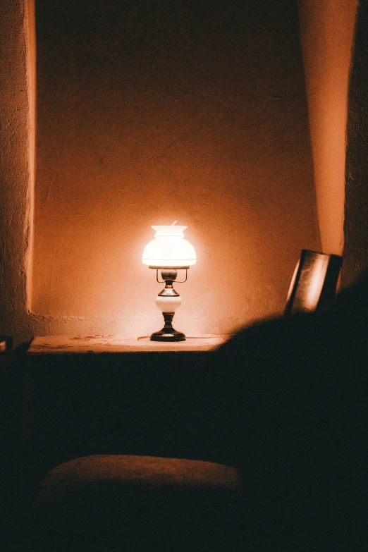 a white lamp on a table next to the wall