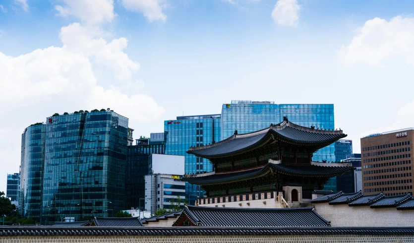 an oriental style building next to a city in the middle of buildings