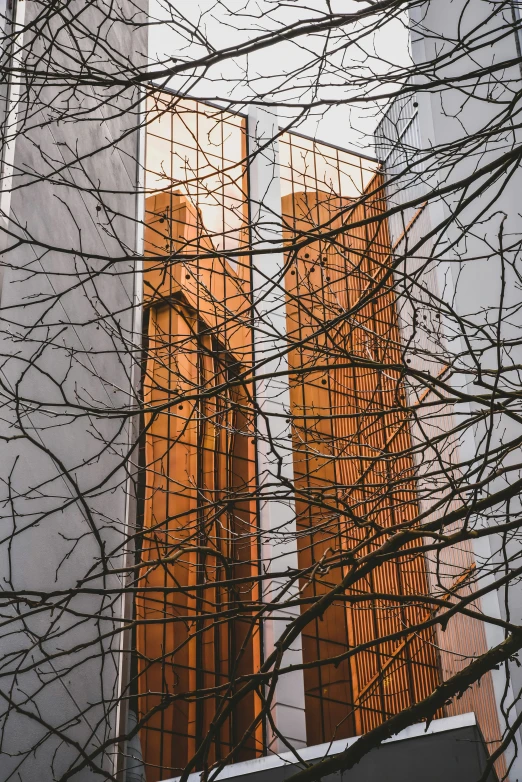 three tall towers with trees on the side