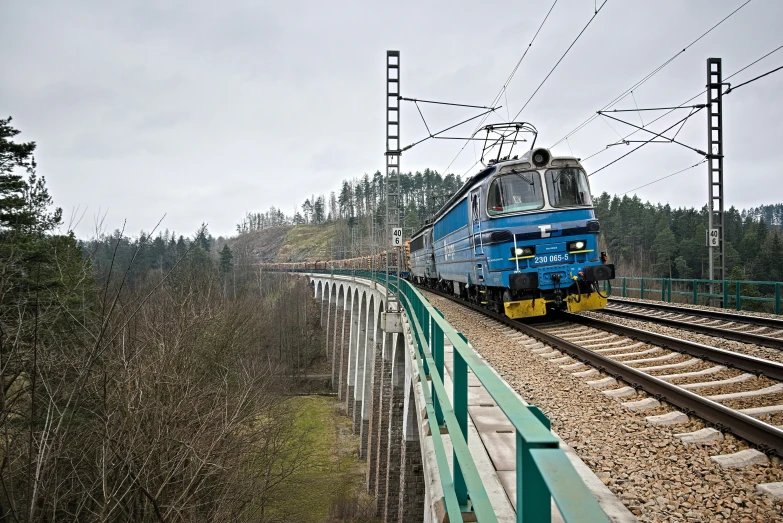 a large blue train going down a track