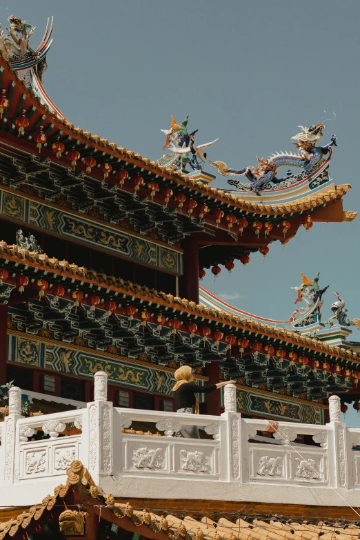 an oriental building with ornate asian decoration and statues on it