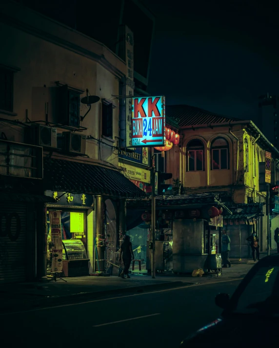 a night view of a street corner in front of an old fashion cafe