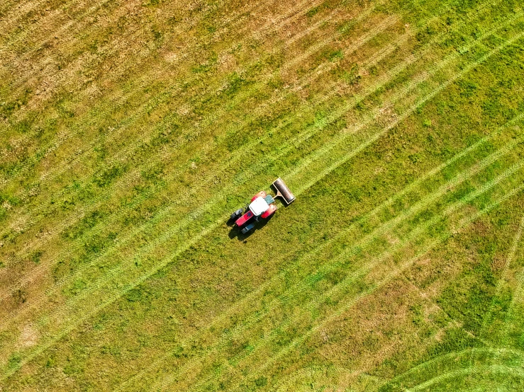 an aerial view of an airplane flying over a farm field