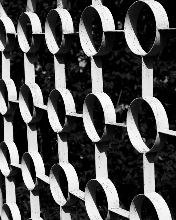 an iron fence is shown with several circles on it