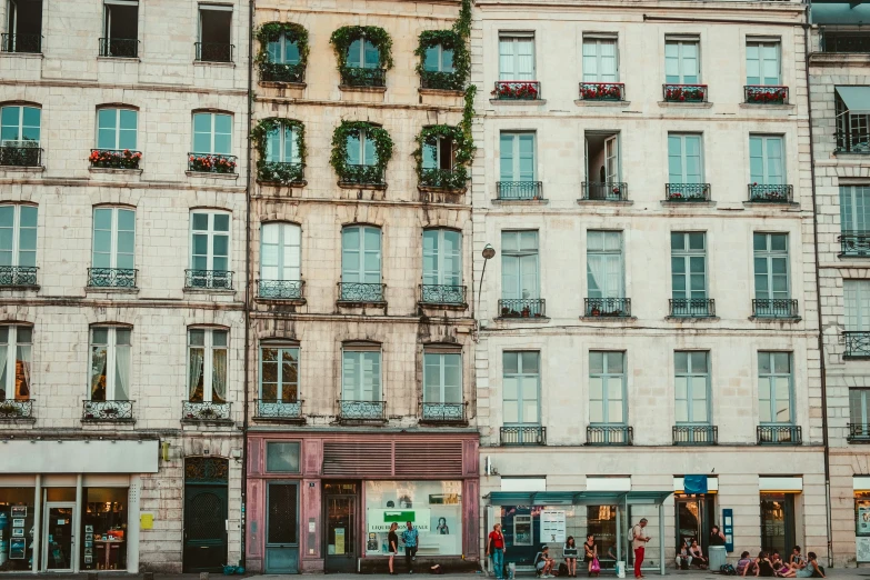 people are on the street in front of a large building