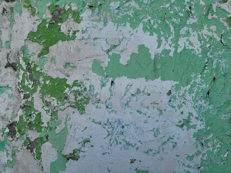a close up of peeling paint on an old wall