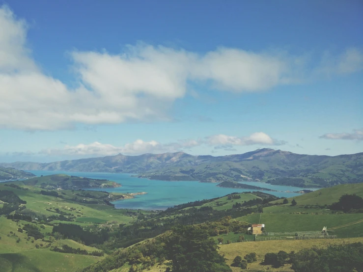 green rolling hills with a lake in the background