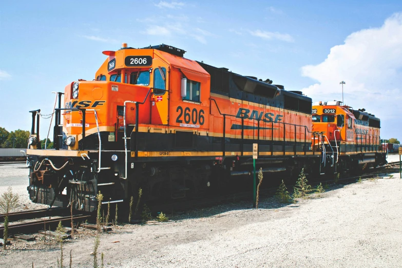 an orange train engine is on a track