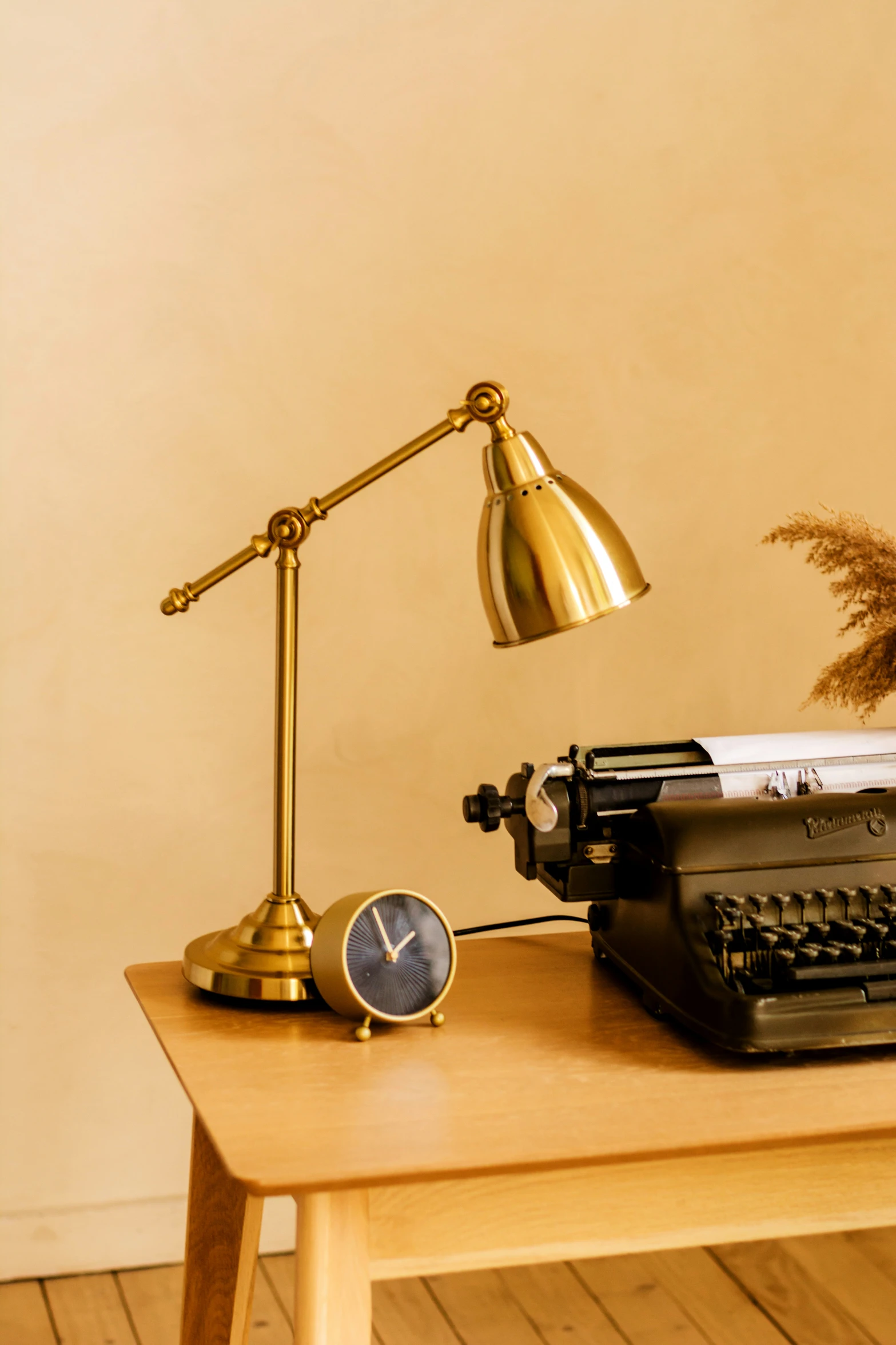 a lamp on top of a table with an old typewriter