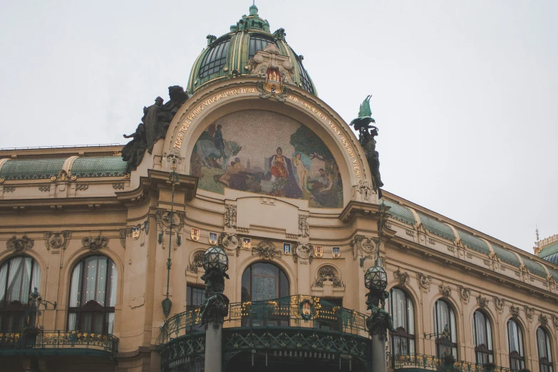 a building with statues on top has many windows