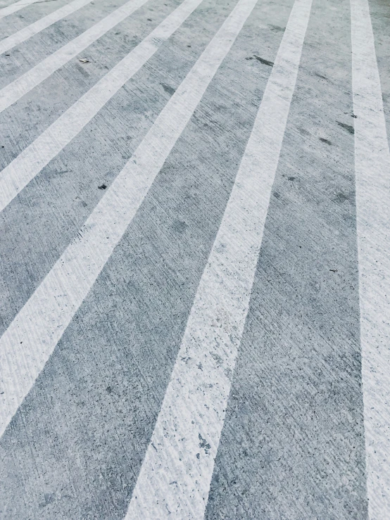 the view of an asphalt street shows different shades of white