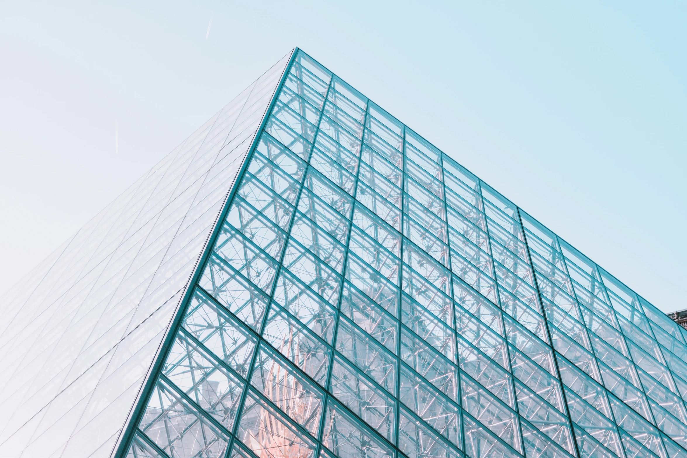 a tall glass building with many windows on top