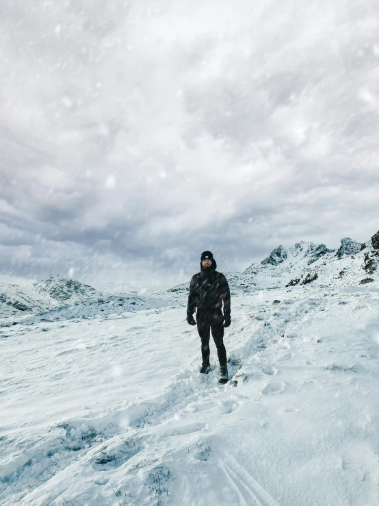 a man hiking in the snow with no shoes on