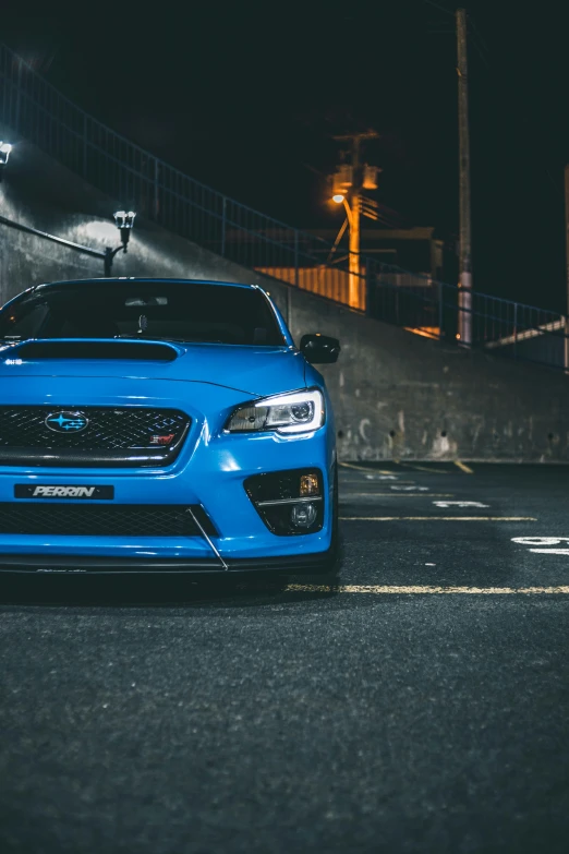 a blue subarunt parked in the middle of the street