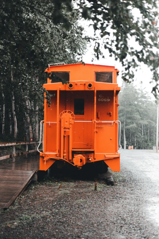 an orange truck that is parked in the rain