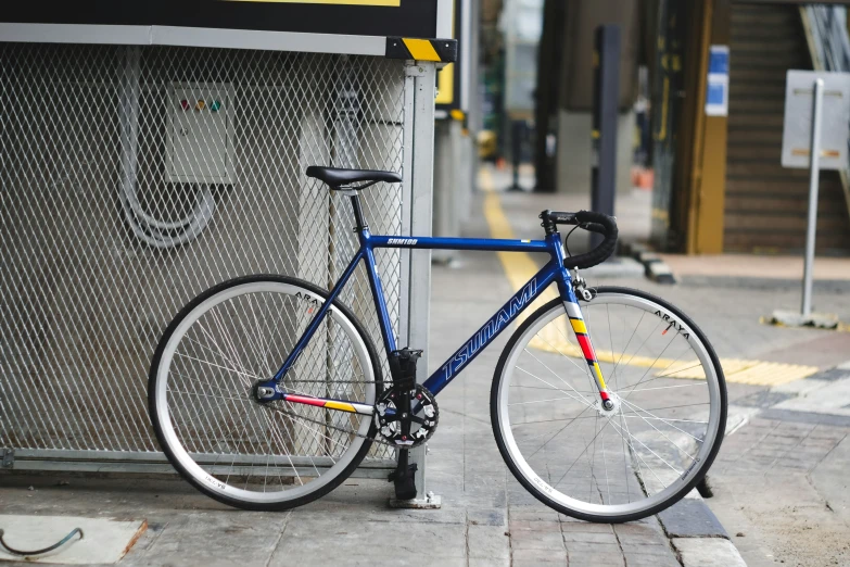 a blue bicycle sitting outside of a store