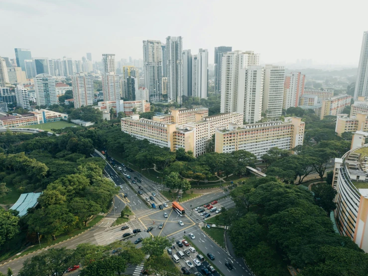 an aerial view of city with cars, buses and buildings