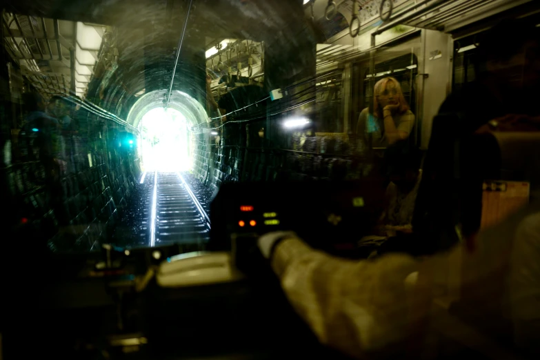 the woman is standing in front of the entrance to the tunnel