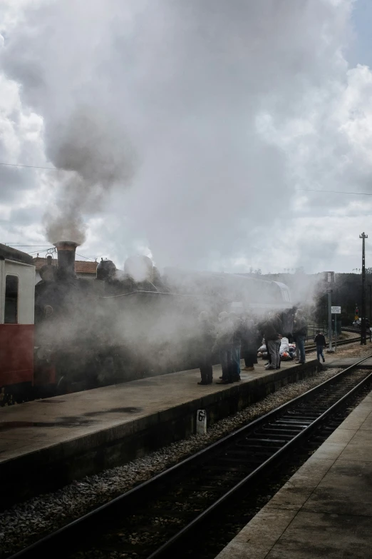 steam is coming from the back of a train