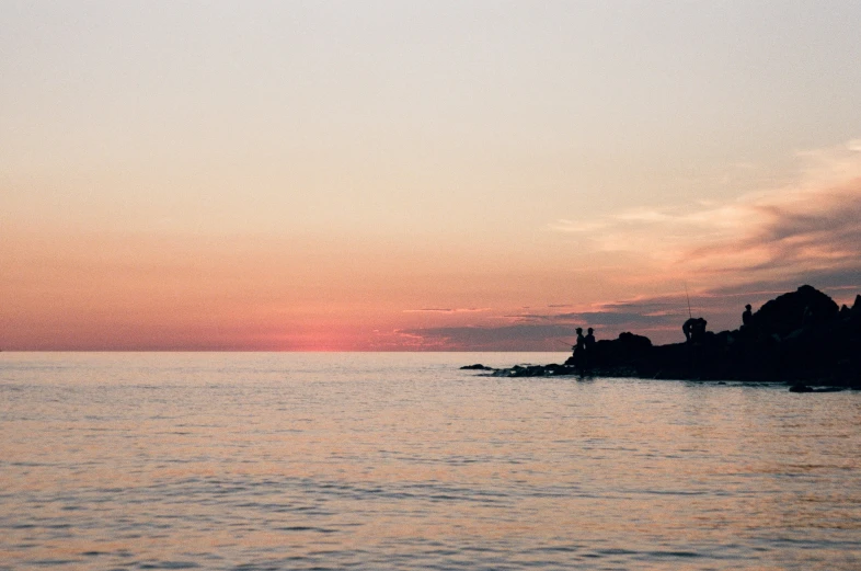 a couple of lighthouses sitting on top of a rocky hill