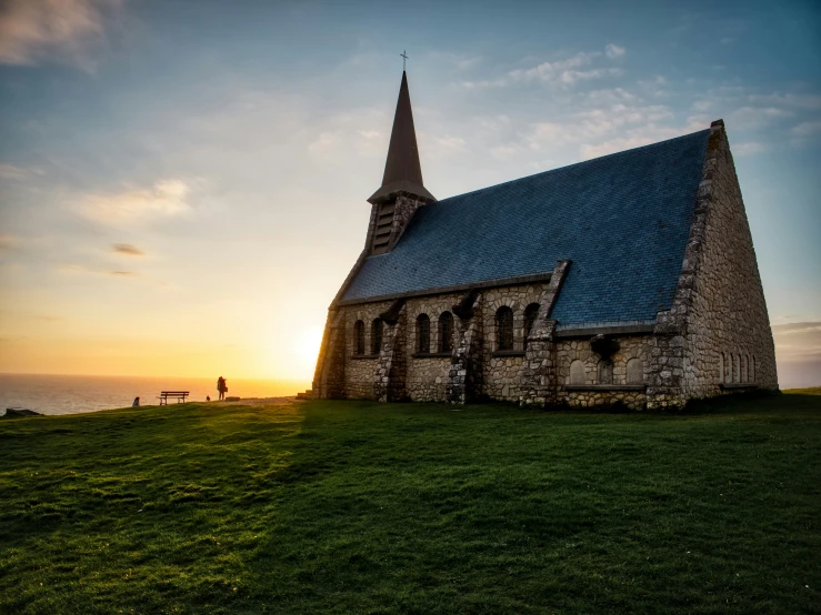 a church with the sun in the background