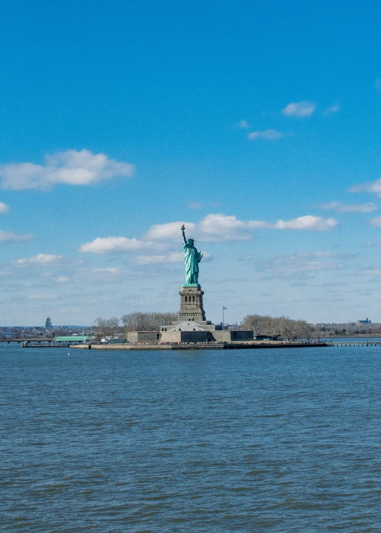 a boat in the water near a statue