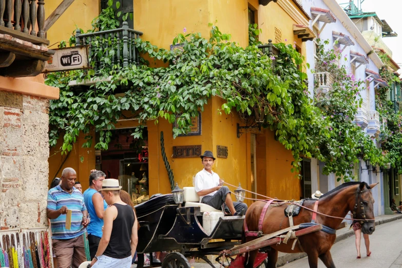 a horse drawn carriage is pulled up to a building