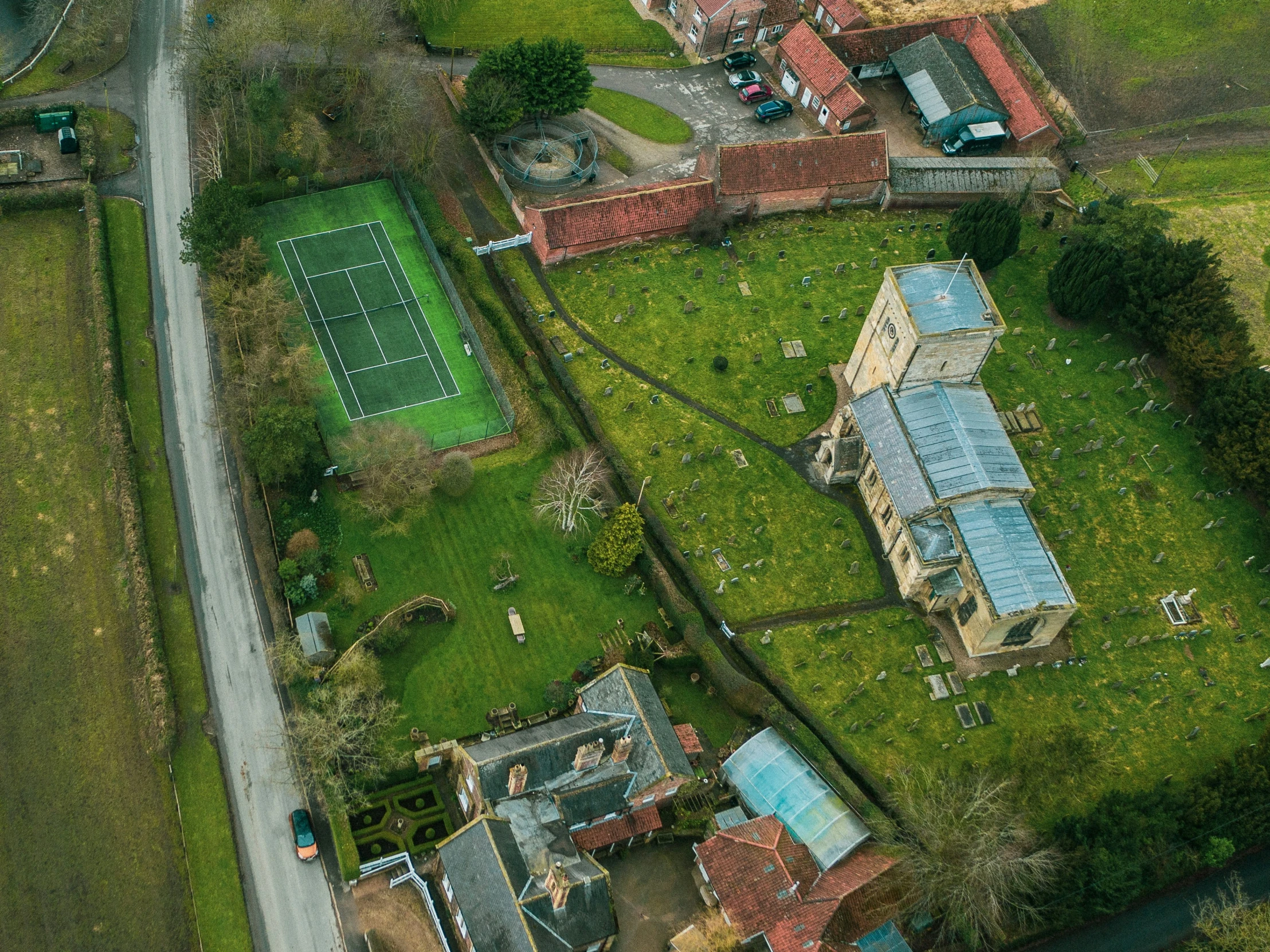 an aerial view of the green grass and houses